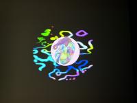 Multicolored image of a person hugging their knees to their chest