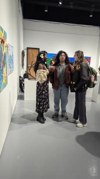 People talking while looking at artwork