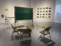 Picture of desks sitting around a chalkboard