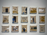 Picture of 15 artworks hanging on the wall depicting a classroom