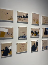 Picture of artworks hanging on the wall, depicting a classroom