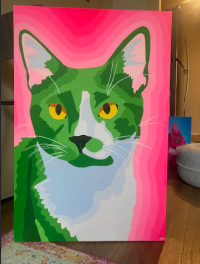 A green, blue, and pink painting of a cat head-on with a pink background
