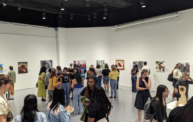 Visitors attend an opening in the Maril Gallery